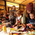 Garrett Wade, 6, right, gets some help from his mother, Meshell Wade of Fayetteville, while making a...
