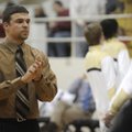 Bentonville assistant coach Brandon Cole encourages players as they warm up Dec. 18.
