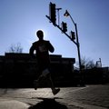 A runner rounds the corner at Dickson Street and West Avenue on Friday during the Twenty 10K foot ra...