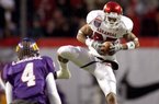 Arkansas wide receiver Greg Childs pulls in a reception over East Carolina defensive back Van Eskridge during the first quarter Saturday at the Liberty Bowl in Memphis, Tenn.