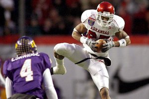 Arkansas wide receiver Greg Childs pulls in a reception over East Carolina defensive back Van Eskridge during the first quarter Saturday at the Liberty Bowl in Memphis, Tenn.