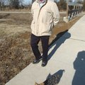 Paul Spiller of Rogers and his silky terrier, Misty, walk along the Rogers trail system on Friday ne...