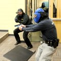 Law enforcement officers enter a room during an exercise at Barker Middle School in Bentonville on D...