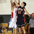 Rogers Heritage’s Jack McMillan, right, jumps for a rebound with Webb City, Mo., forward Andrew Pise...