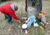 Johnnie Turner straightens items at a memorial Sunday afternoon for his brother-in-law, Timmy Wayne Nichols, who was gunned down in 2008 at West 15th and Crutcher streets in the North Little Rock neighborhood of Baring Cross.
