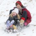 Eden Graves, 5, left, of Springdale laughs while riding downhill Sunday with her aunt, Leah Hale, an...
