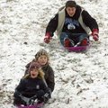 Marcus Still, 16, of Fayetteville gives himself a push while trying to catch his cousin Shelby Speer...
