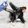 Ryan Alley takes a spill Monday after a fast ride down a Bella Vista slope on a flexible sled.