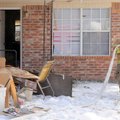 Firefighter Nathan Meeks packs hoses Monday after helping extinguish a garage fire at 1903 S. 18th S...