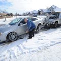 Lee Dancer with A&B Towing pulls Kevin Bailey’s Chevrolet Cobalt from atop the curb along Carley Roa...