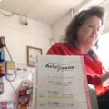 Jayme Hansell works Monday at the Crackerbox Food Store in Mayflower with the winning Powerball numb...