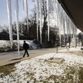 A pedestrian walks up Duncan Avenue on Tuesday in Fayetteville while snow and icicles from weekend w...