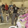 ACADEMY ACTIVITY: Anna Hay, right, tests one of 50 bicycles Academy Sports & Outdoors donated to the...