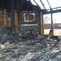 Rogers Assistant Fire Marshall William Rumsey is framed outside a home at 2401 McKinley St. that bur...