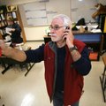 AIMING TO SAVE: Sam Reyna, energy management educator for the Bentonville School District, aims an i...