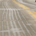 BATTLING ICE: A pedestrian crosses Mountain Street near the Fayetteville square Wednesday a few mome...