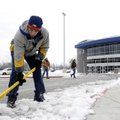 CRUNCH TIME: Oscar Cardona, from left, grounds crew member at Rogers Heritage High School, picks at ...