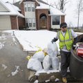 Domigo Perez with Waste Management collects the trash Wednesday in the Cedar Ridge Drive area of Spr...