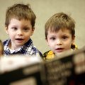  BOOK HAS OUR ATTENTION: Twins Jonathan (left) and Dominic Torres, 5, of Mesa, Ariz., listen Wednesd...