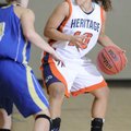 Rogers Heritage’s Yalile Johnson protects the ball while dribbling during a Nov. 24 game against Har...