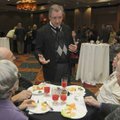Dr. James Arkins talks with guests Thursday during a retirement reception at the Doubletree Guest Su...