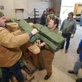 Fayetteville Parks and Recreation Division workers Marshall Wood, left, and Gary Kilpatrick load cot...