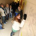 Arts Live Theatre performer Morgan Vesper, 15, signs her name on the wall at the organization’s new ...