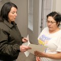 Stoneleigh Apartments resident Maria Carbajal, right, learns Friday from Kaplan Management represent...