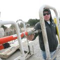 Jon Odom of Lincoln, a lineman for Ozarks Electric Cooperative, puts a tool back in his truck Friday...