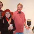 Potter Don Nibert, from right, talks with Amy Wilson and Greg Mitchell at an exhibit of his Raku-fir...