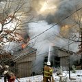 Firefighters from the Rocky Branch, Piney Point, Beaver Lake and Rogers fire departments try to cont...