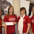 Sarah Eldridge, left, of Pagnozzi Charities, accepts a check from three former members of the NWA Tw...