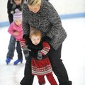 Ava Ahern, 2, receives some help from her mother, Christine, of Springdale as she tries ice skating ...