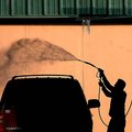  Arkansas Democrat-Gazette/WILLIAM MOORE
A driver takes advantage of a clear day to wash residue fr...