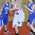 Rogers Heritage’s Ellen Lundy pulls down a rebound between two Rogers High defenders during the seco...