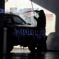 WASHING AWAY WINTER
Leonardo Aguayo washes soap from his Jeep Grand Cherokee on Tuesday at the Oasi...