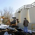 Jake McDonald, left, a technician with Mid-America Environmental Solutions of Carthage, Mo., operate...
