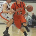 Springdale Southwest’s Alex Scharlau, right, drives around Rogers Heritage defender Bryce Roth durin...