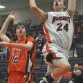 Rogers Heritage freshman Jamie Lovelace shoots after driving around Springdale Southwest defender Al...