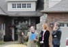 Real estate agent Austin Bivens, left, shows prospective buyers Judy and Craig Bratten the Arkanshire neighboorhood in Springdale on Friday.