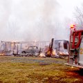 Firefighters watch and wait Friday while fire destroys this home along Gailey Hollow Road near Highf...