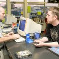 CATERING TO CUSTOMERS Take 2 Video manager Boyd Rubendall, left, waits Tuesday on customer Jack Dani...