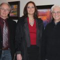 Artist Charles Peer, from right, visits with Teresa and Rick Parker on Thursday evening.