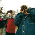 Cathy Ross, left, Ben Sherrill, 12, and Alex Baron, 10, peer out at bird on Beaver Lake on Saturday ...