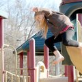 Farrah Russo, 9, makes a 6-foot jump to the sand below the playground equipment at Lake Bella Vista ...