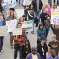 Students hold signs calling for a Bentonville High School gay-straight alliance while participating ...