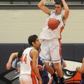 Rogers Heritage’s Nick Jordan lets go of the rim after a dunk during Friday night’s game against 7A-...