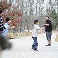 Ricky Borgas, 19, looks for a teammate to throw the football to as Marcous Borgas, 13, from left, Ra...