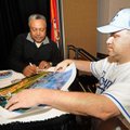 Greg Goodwin, right, of Decatur gets autographs Monday from Frank White, a former Kansas City Royals...