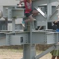 Penelope Starr, 10, of Fayetteville climbs down from the Chi Epsilon sculpture on the University of ...